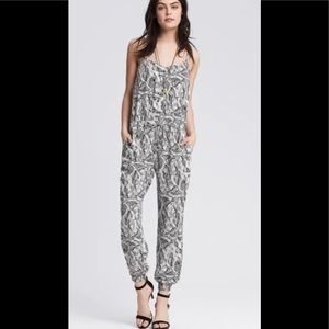 Black and white print jumpsuit with adjustable spaghetti straps.
